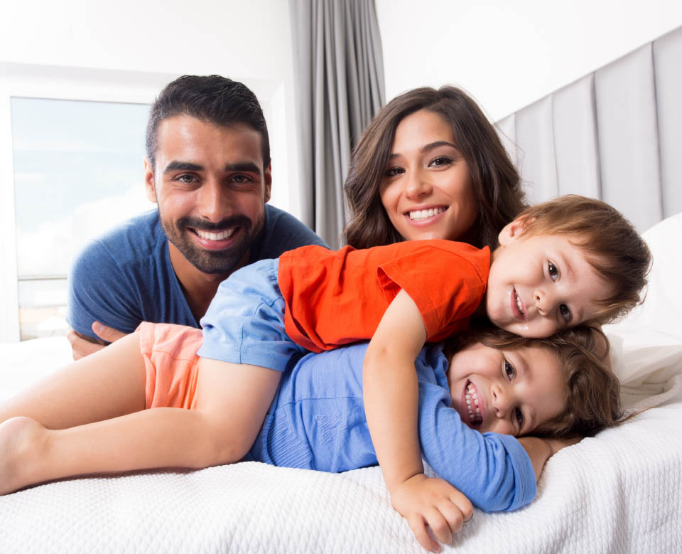 Happy family enjoying the morning in bed